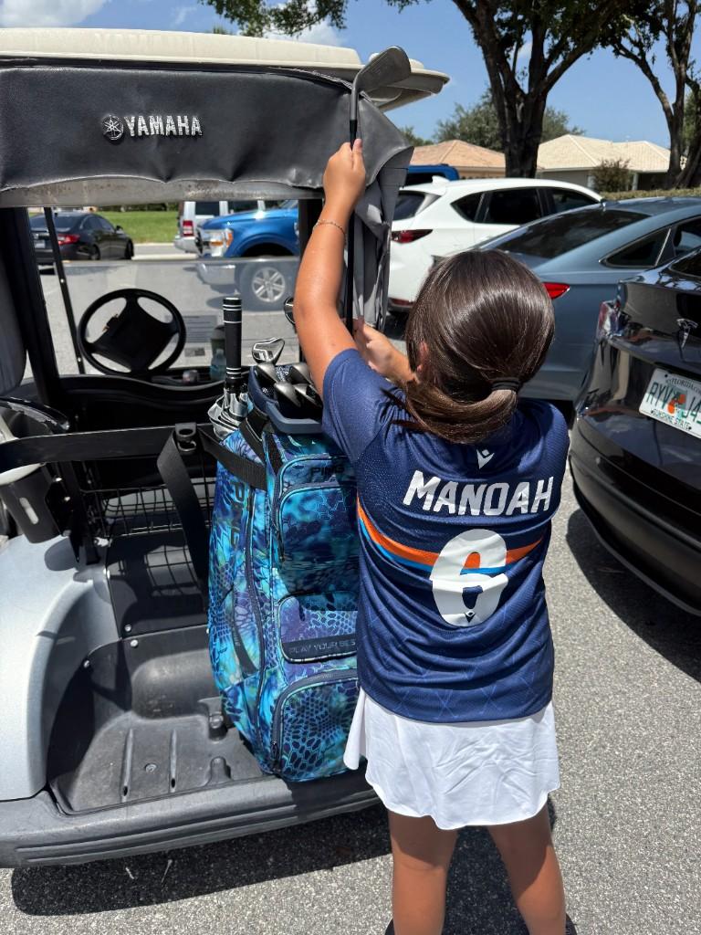Alex getting clubs from the golf bag